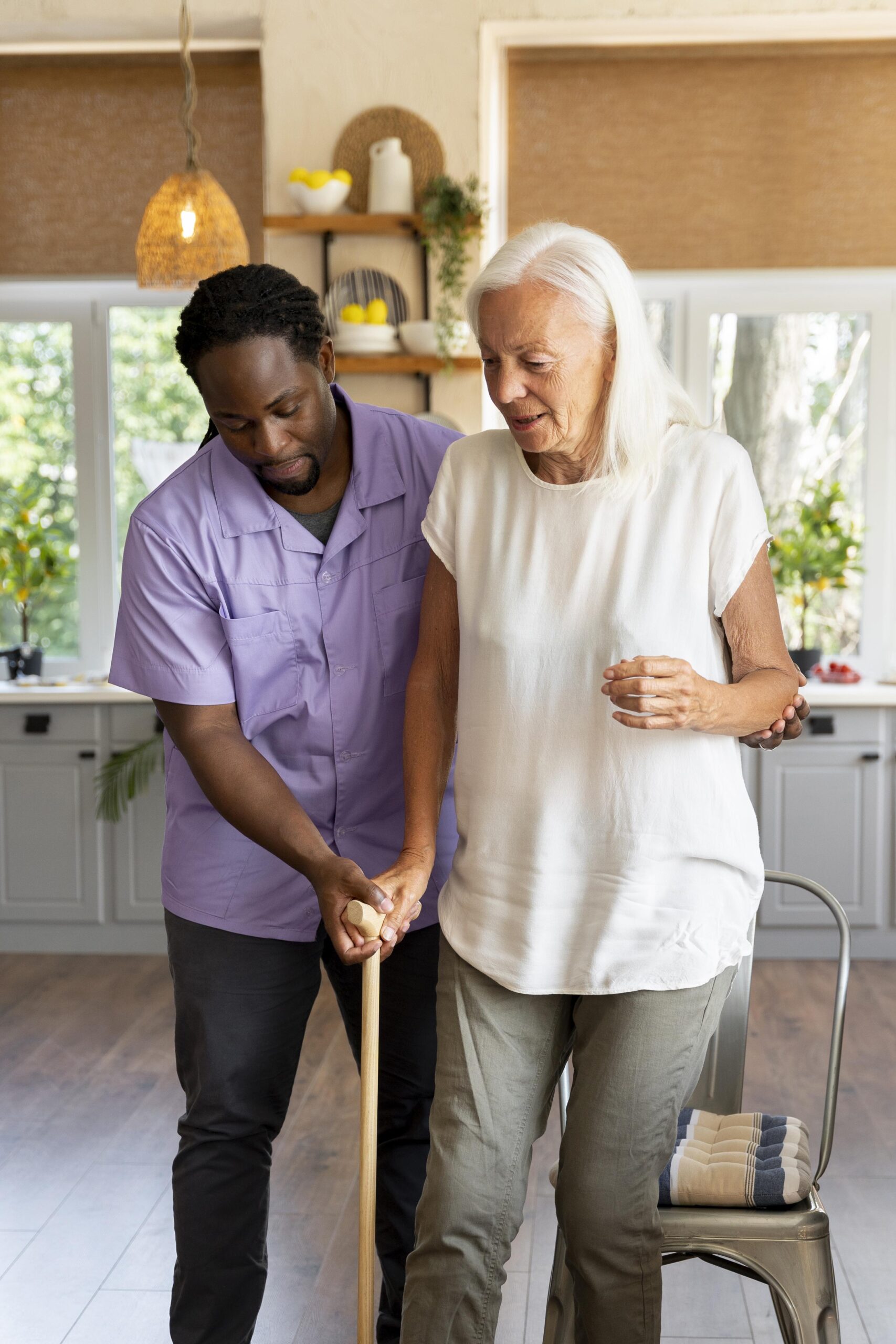 Caregiver assisting an elderly man with mobility support and in-home care in the Tampa Area, FL